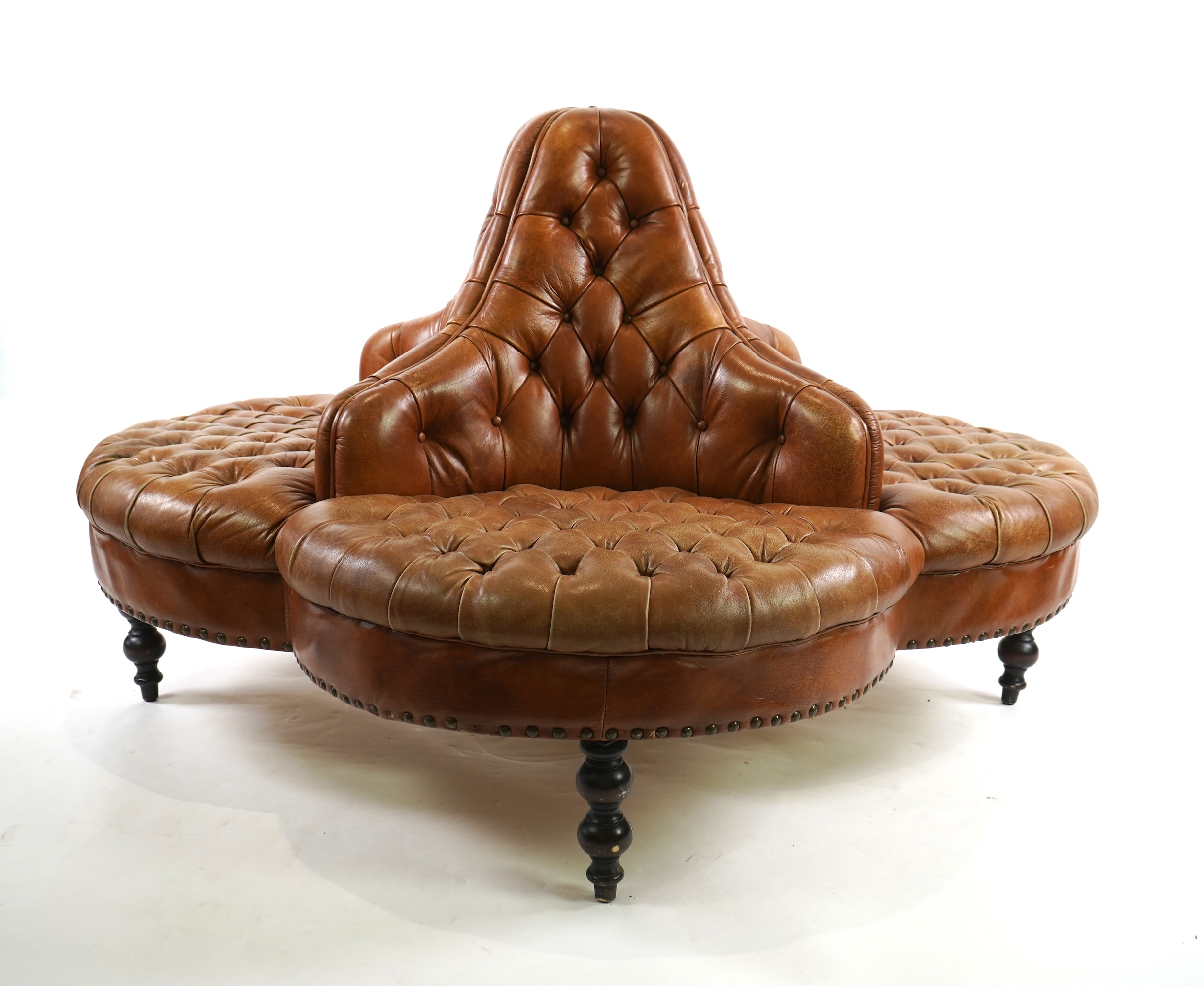 A contemporary Victorian style buttoned tan leather conversation seat
